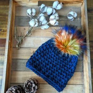 Navy blue hat with birds of paradise pompom